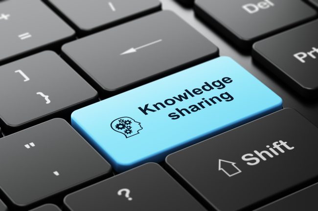 Education concept: Head Gears and Knowledge Sharing on keyboard